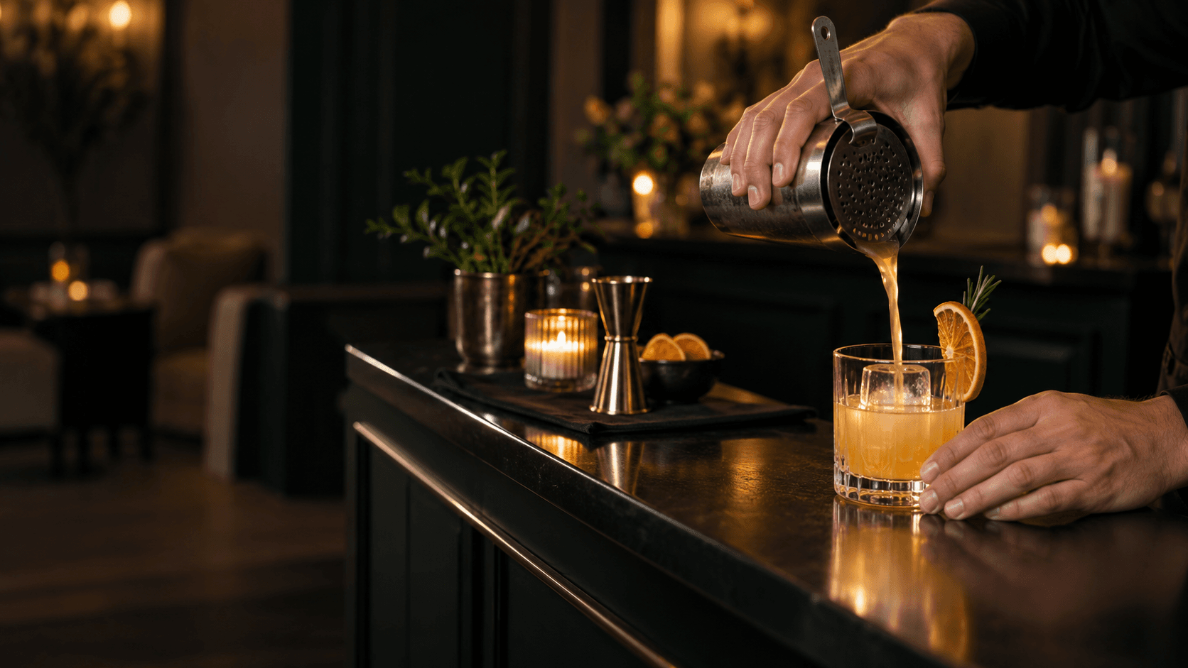 A bartender pouring a drink at a prepared bar